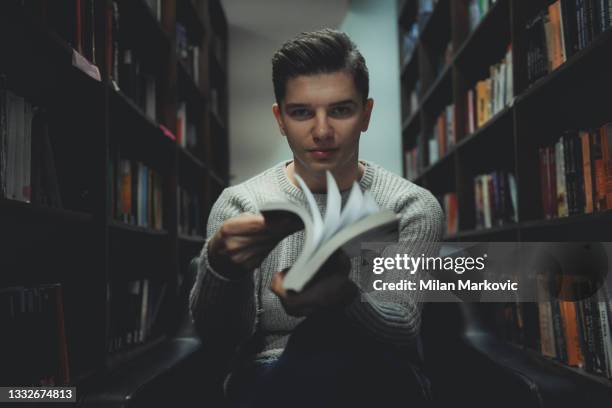 student in the library searches for literature - man reading card stock pictures, royalty-free photos & images