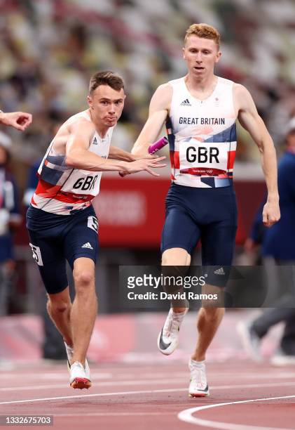 Joe Brier of Team Great Britain takes the baton from team mate Cameron Chalmers in the Men's 4x400 metres relay heats on day fourteen of the Tokyo...