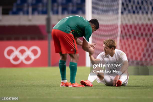 Ritsu Doan of Team Japan looks dejected as he is consoled by Luis Romo of Team Mexico following defeat in the Men's Bronze Medal Match between Mexico...