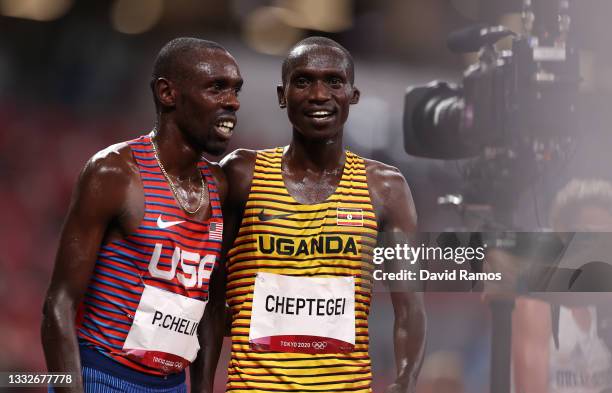Bronze medal winner Paul Chelimo of Team USA and gold medal winner Joshua Cheptegei of Team Uganda celebrate after the Men's 5000 metres final day...