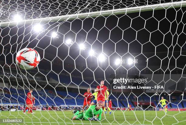 Stephanie Labbe of Team Canada looks on as Stina Blackstenius of Team Sweden scores their team's first goal during the Women's Gold Medal Match...