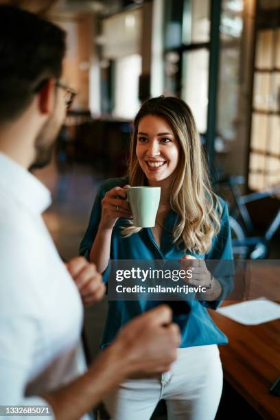 colleagues drinking coffee in the office - coffee break stock pictures, royalty-free photos & images