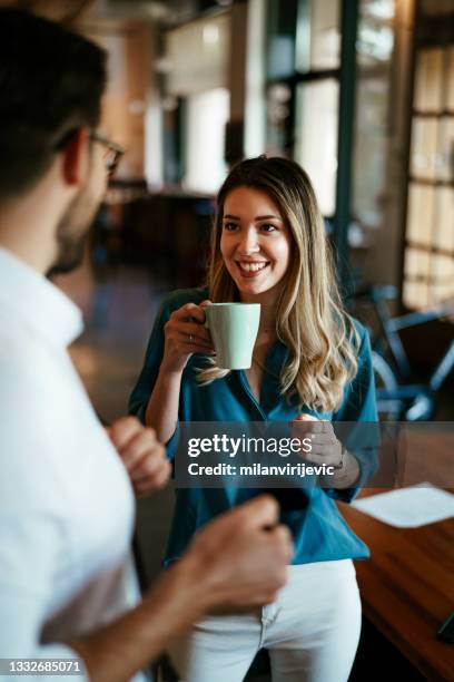 colleagues drinking coffee in the office - coffee break office stock pictures, royalty-free photos & images