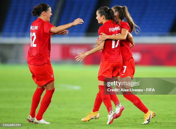 Jessie Fleming of Team Canada celebrates with Christine Sinclair and Julia Grosso after scoring their team's first goal during the Women's Gold Medal...