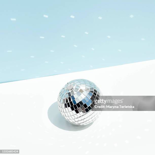 disco ball of silver color on a blue background. - silver disco ball stock pictures, royalty-free photos & images