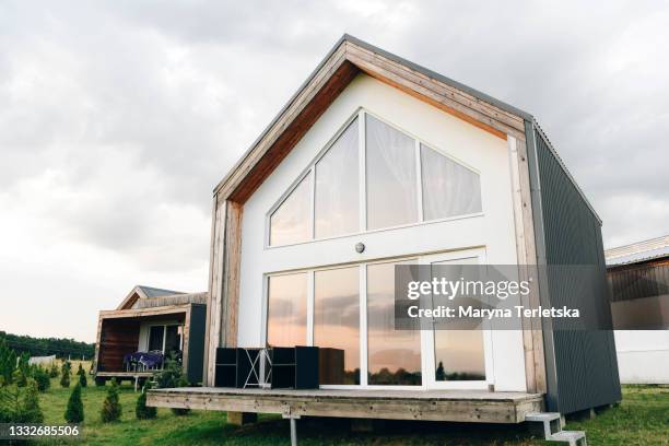 large beautiful country house with large windows. - cabaña de madera fotografías e imágenes de stock