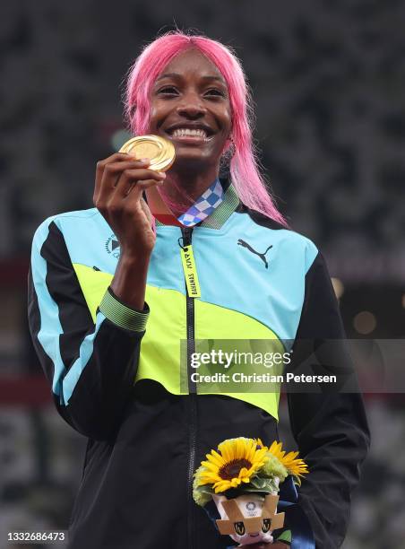 Gold medalist Shaunae Miller-Uibo of Team Bahamas holds up her medal on the podium during the medal ceremony for the Women's 400m on day fourteen of...