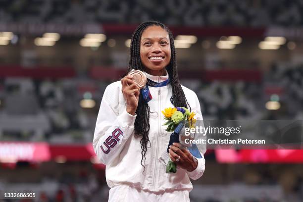 Bronze medalist Allyson Felix of Team USA holds up her medal on the podium during the medal ceremony for the Women's 400m on day fourteen of the...
