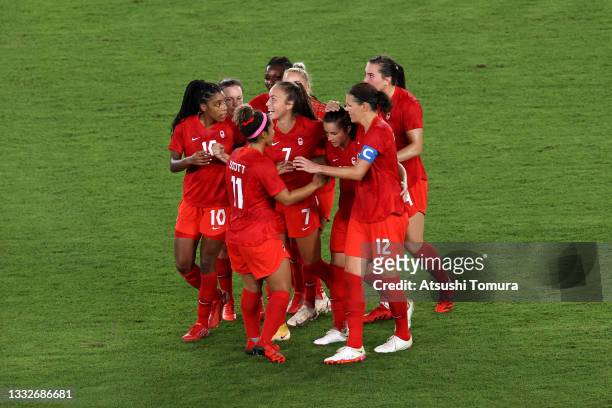 Jessie Fleming of Team Canada celebrates with team mates after scoring their side's first goal during the Women's Gold Medal Match between Canada and...