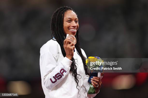 Bronze medalist Allyson Felix of Team USA holds up her medal on the podium during the medal ceremony for the Women's 400m on day fourteen of the...