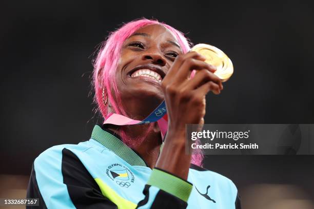 Gold medalist Shaunae Miller-Uibo of Team Bahamas holds up her medal on the podium during the medal ceremony for the Women's 400m on day fourteen of...