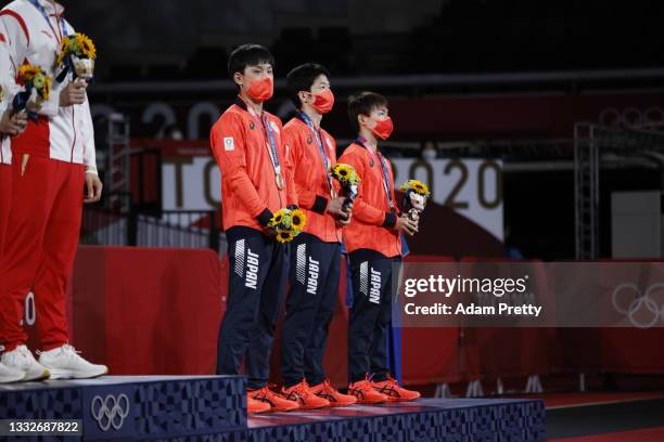 Team Japan players Harimoto Tomokazu, Mizutani Jun, and Koki Niwa pose with their medals during the medal ceremony of the Men's Team table tennis on...