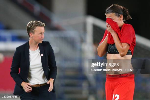 Christine Sinclair of Team Canada reacts as she walks off the pitch after being substituted off as Bev Priestman, Head Coach of Team Canada looks on...