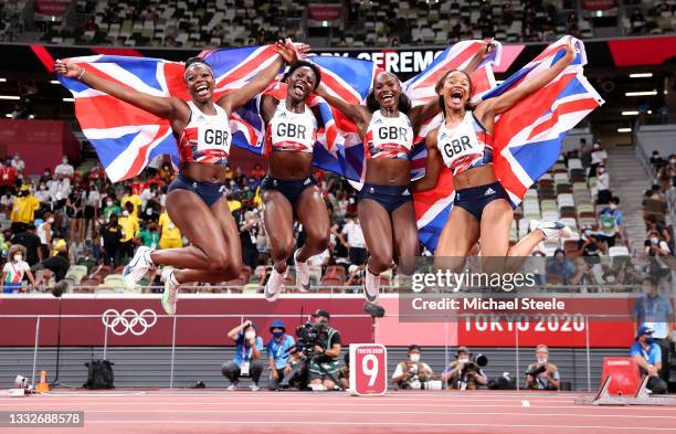 Asha Philip, Imani Lansiquot, Dina Asher-Smith and Daryll Neita of Team Great Britain celebrate winning the bronze medal in the Women's 4 x 100m...