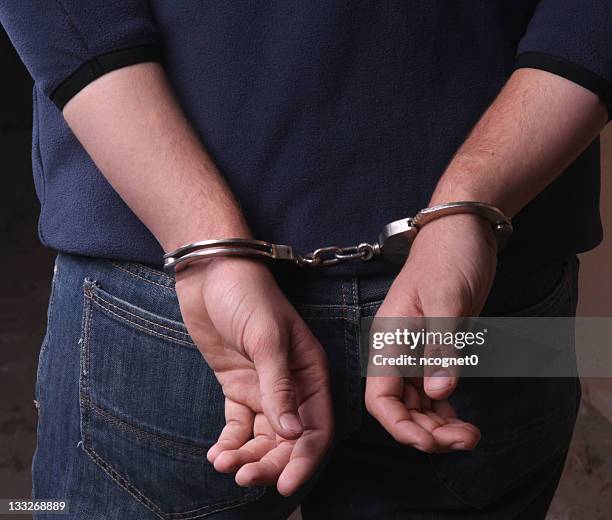 criminal handcuffed by the police - arrest stock pictures, royalty-free photos & images