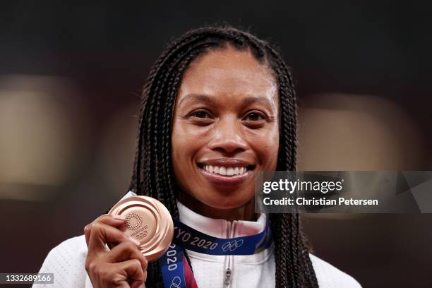 Bronze medalist Allyson Felix of Team USA holds up her medal on the podium during the medal ceremony for the Women's 400m on day fourteen of the...