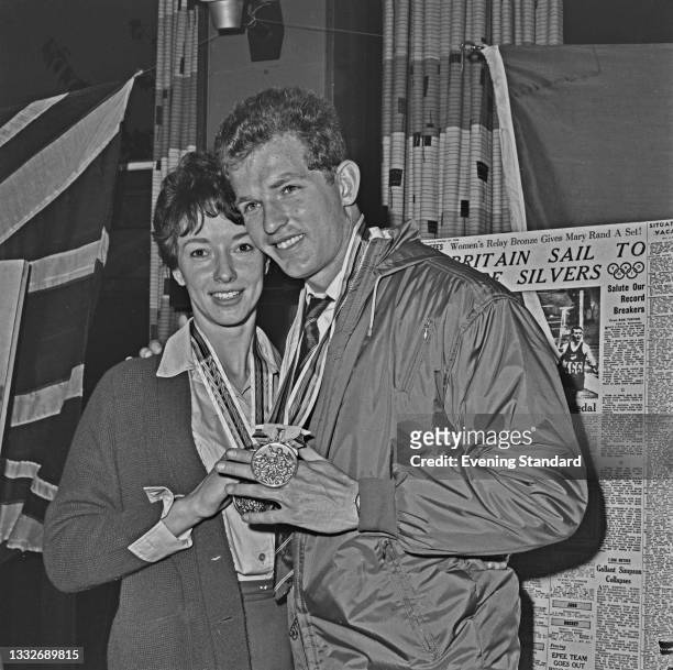 English athlete Ann Packer and Robbie Brightwell upon their return from the 1964 Summer Olympics in Tokyo, UK, 29th October 1964. They are wearing...
