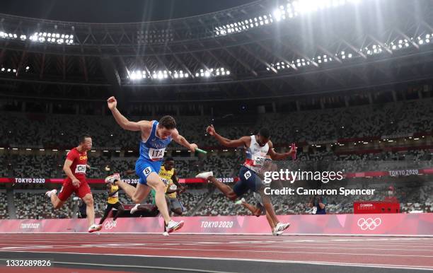 Filippo Tortu of Team Italy beats Nethaneel Mitchell-Blake of Team Great Britain across the finish line to win the gold medal in the Men's 4 x 100m...