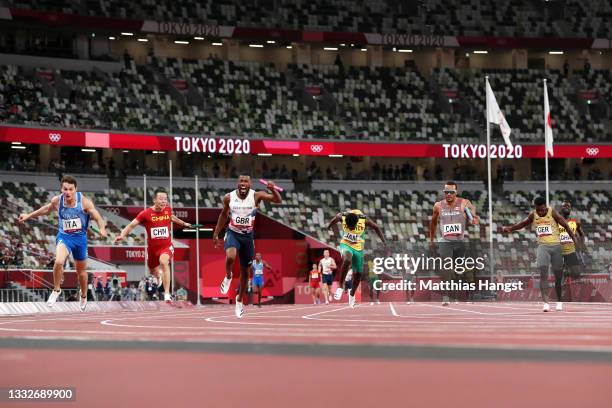 Filippo Tortu of Team Italy beats Nethaneel Mitchell-Blake of Team Great Britain across the finish line to win the gold medal in the Men's 4 x 100m...