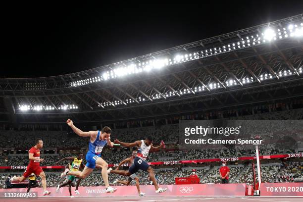 Filippo Tortu of Team Italy beats Nethaneel Mitchell-Blake of Team Great Britain across the finish line to win the gold medal in the Men's 4 x 100m...
