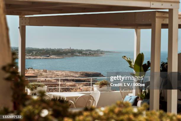 scenic view of sea seen through window,polignano a mare,bari,italy - bari stockfoto's en -beelden