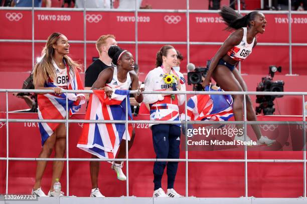 Imani Lansiquot, Asha Philip, Laura Muir and Dina Asher-Smith of Team Great Britain show their support for Team Great Britain in the Men's 4 x 100m...