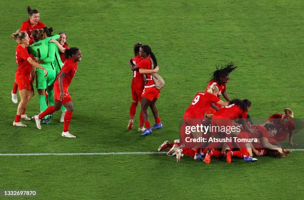 Julia Grosso of Team Canada celebrates with team mates after scoring their sides winning penalty in the penalty shoot out in the Women's Gold Medal...