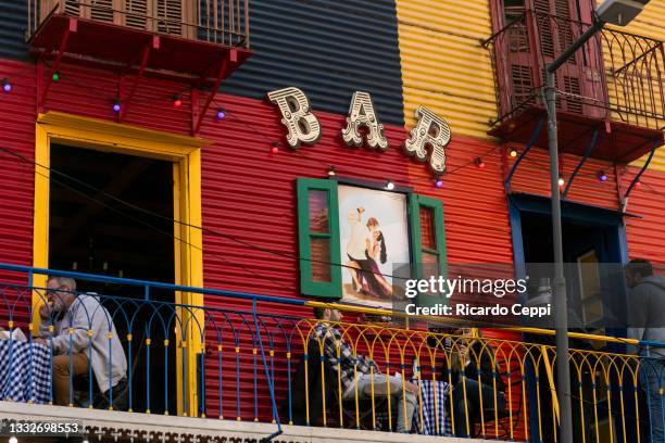 Tourists are seen on a balcony of a bar at La Boca neighborhood on August 01, 2021 in Buenos Aires, Argentina. Due the progress in the vaccination...