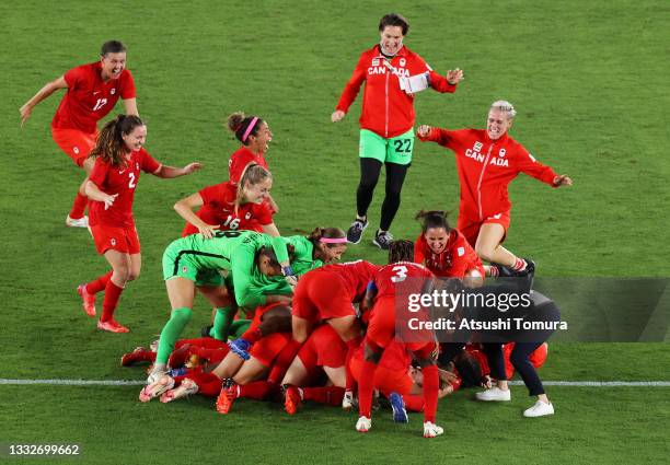 Julia Grosso of Team Canada celebrates with team mates after scoring their sides winning penalty in the penalty shoot out in the Women's Gold Medal...