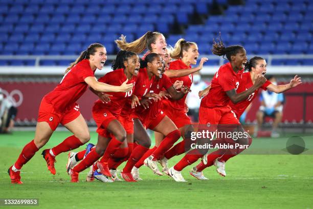 Team Canada celebrates after defeating Team Sweden in a penalty shoot-out to win gold in the women's football gold medal match between Canada and...