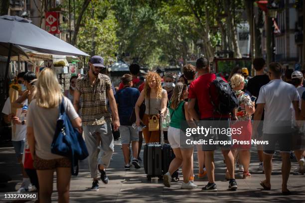 People walk along Las Ramblas on August 5 in Barcelona, Catalonia, Spain. Barcelona faces a tourist season this summer marked by the fifth wave of...