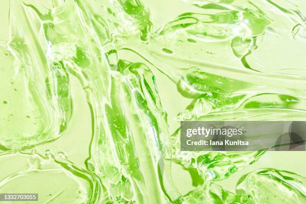 antibacterial aloe vera gel with bubbles. transparent green smudged of liquid moisture serum for face. hydrating hyaluronic acid. cosmetic products for skincare. cosmetology. - gel foto e immagini stock