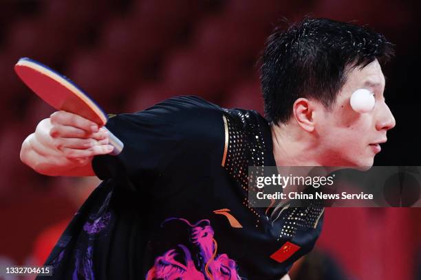 Ma Long of Team China comeptes against Timo Boll of Team Germany during the Men's Team Gold Medal table tennis match on day fourteen of the Tokyo...
