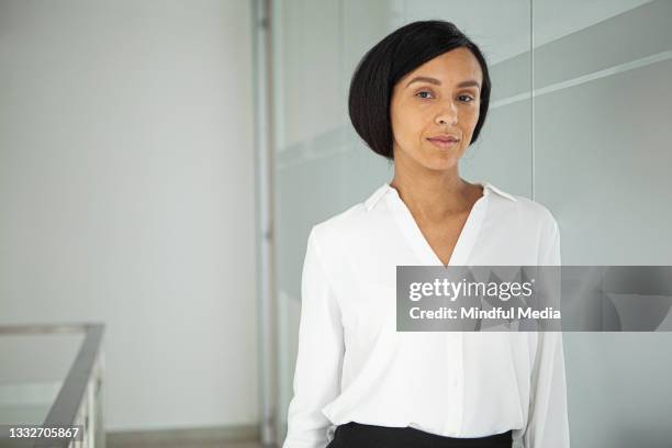 confident young adult latin businesswoman looking at the camera - medium shot stock pictures, royalty-free photos & images