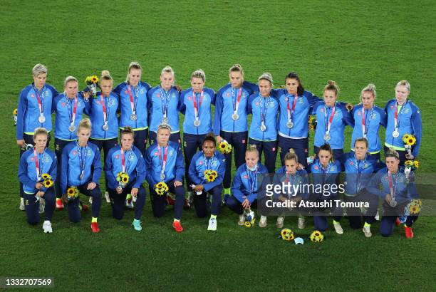 Silver medalists of Team Sweden pose with their silver medals during the Women's Football Competition Medal Ceremony on day fourteen of the Tokyo...