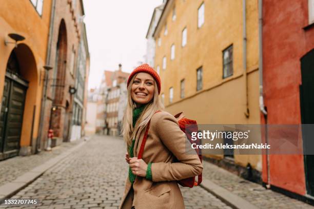 young smiling woman on a city break - copenhagen tourist stock pictures, royalty-free photos & images