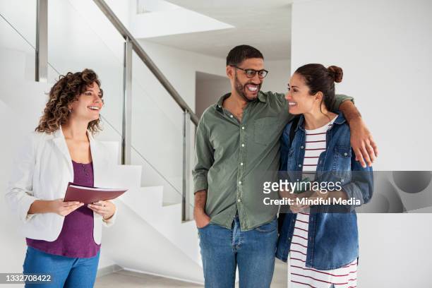 happy young latin couple talking with real estate agent - house viewing stock pictures, royalty-free photos & images
