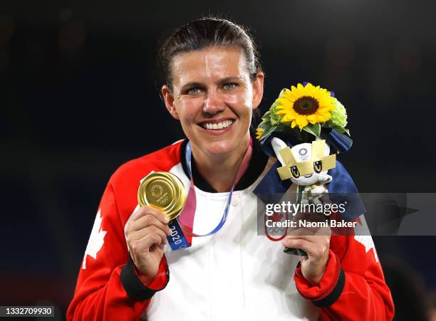 Gold medalist Christine Sinclair of Team Canada poses with her gold medal during the Women's Football Competition Medal Ceremony on day fourteen of...