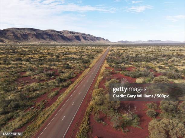 high angle view of road amidst landscape against sky,telfer,western australia,australia - country town australia stock pictures, royalty-free photos & images