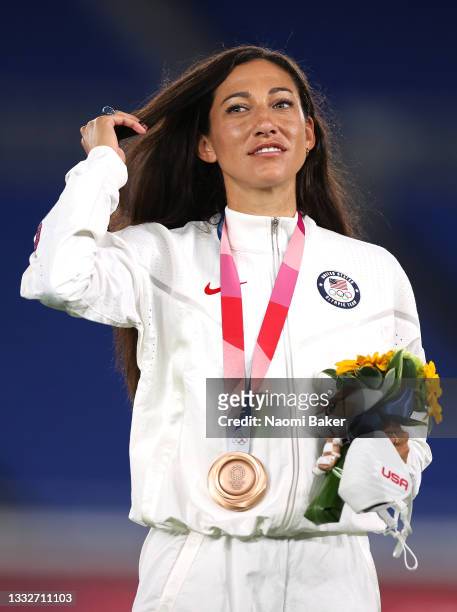 Bronze medalist Christen Press of Team United States looks on with her bronze medal during the Women's Football Competition Medal Ceremony on day...