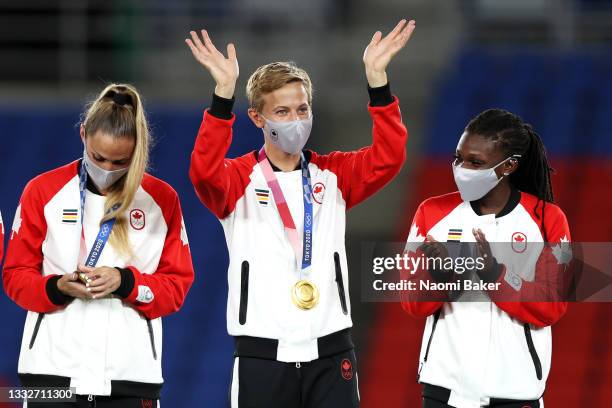 Gold medalist Quinn of Team Canada waves with their gold medal during the Women's Football Competition Medal Ceremony on day fourteen of the Tokyo...