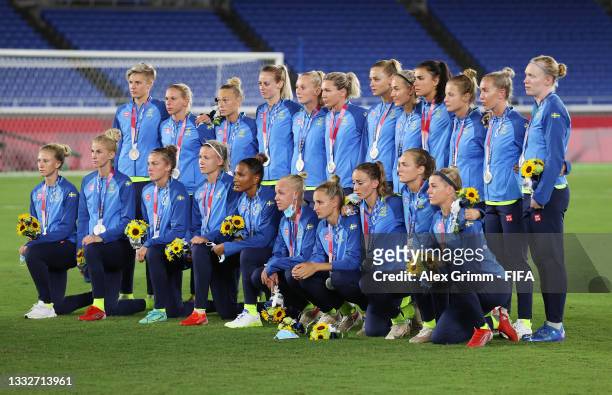 Silver medalists of Team Sweden pose with their silver medals during the Women's Football Competition Medal Ceremony on day fourteen of the Tokyo...