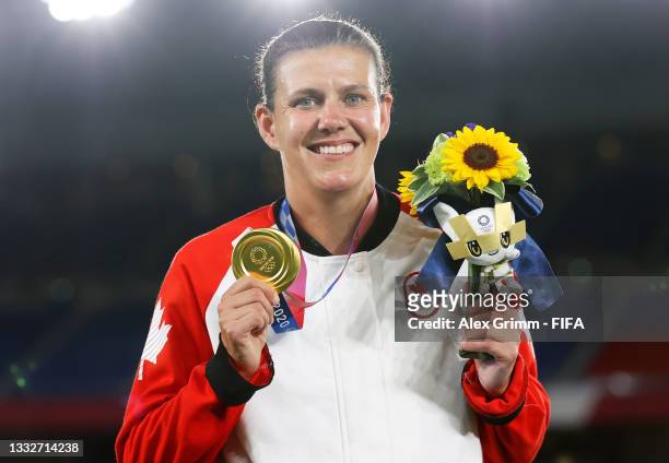 Gold medalist Christine Sinclair of Team Canada poses with their gold medal during the Women's Football Competition Medal Ceremony on day fourteen of...