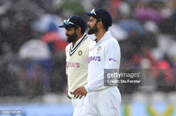 India captain Virat Kohli leaves the field when rain stops play in the final session during day three of the First Test Match between England and...