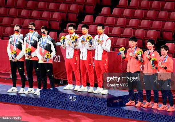 Silver medalists Timo Boll, Patrick Franziska and Dimitrij Ovtcharov of Team Germany, gold medalists Fan Zhendong, Ma Long and Xu Xin of Team China,...