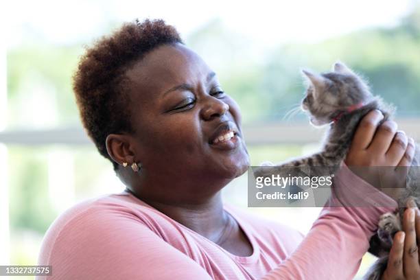 african-american woman holding meowing kitten - meowing bildbanksfoton och bilder