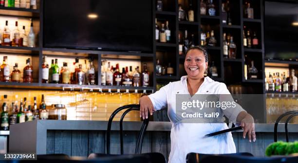 mixed race woman working as server in restaurant bar - filipino ethnicity and female not male 個照片及圖片檔