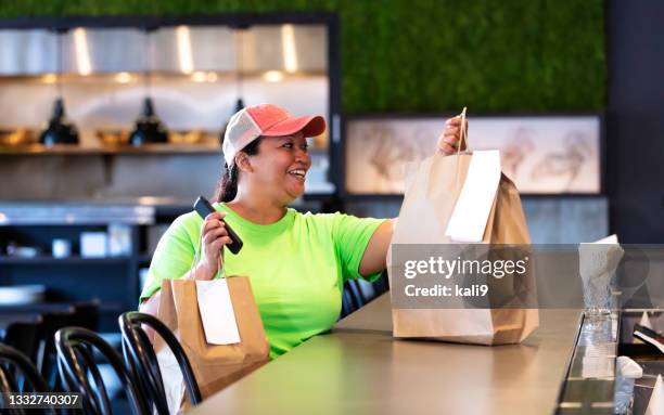 delivery person picking up restaurant takeout food order - picking up food stock pictures, royalty-free photos & images