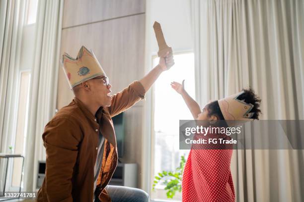 father and daughter playing with superhero at home - reality kings 個照片及圖片檔