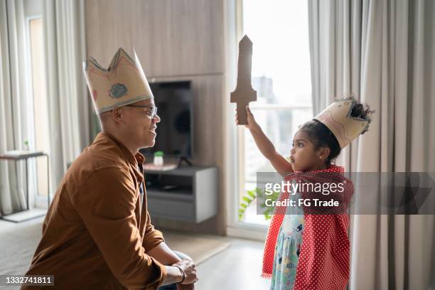 father and daughter playing with superhero at home - stage costume stock pictures, royalty-free photos & images